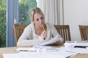 Woman with debts worrying